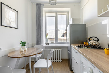 Bright Kitchen with Dining Table, Window and Wooden Countertop