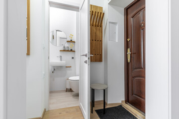 Modern Entryway with View into Minimalist Bathroom