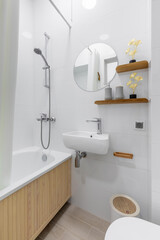 Modern Small Bathroom with Bathtub and Round Mirror