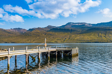 Coast and wooden pier in Fáskrúðsfjörður, Iceland