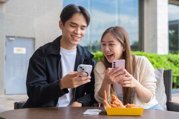 Asian couple eating fried chicken