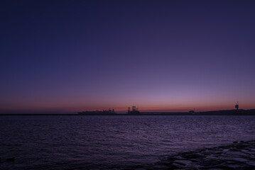 Fototapeta premium LNG TERMINAL AND SUNRISE - Gas tanker at the transshipment quay 