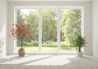 Bright room with large window, potted plants, and view of trees