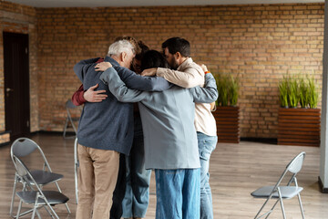 Teammates hugging each other during group therapy session