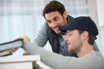 Obraz premium servicemen fixing induction stove in the kitchen