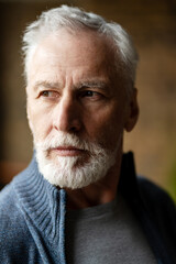 Close up of senior man with white beard looking away