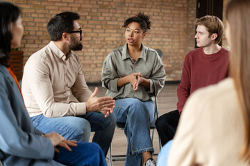 Diverse group of people sharing during group therapy session