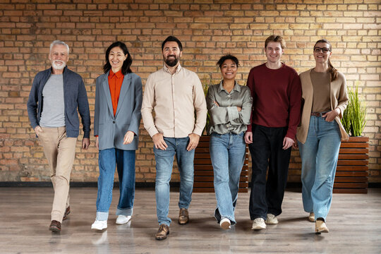 Diverse business team walking forward in modern office