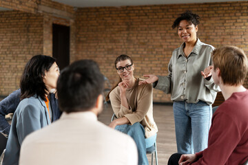 Fototapeta premium Young business coach leading a team meeting in a modern office