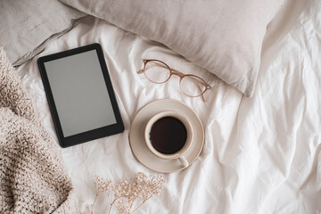 office flat lay with a cup of coffee, glasses and a tablet