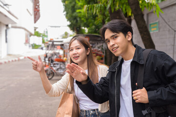 happy young couple waiting for taxi