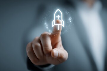 High quality photo of businessman touching a rocket icon with a plus sign on a virtual screen. Close-up view of a hand and finger pointing at a space ship symbol floating in the.