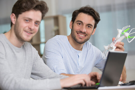 cute boy and his father playing with drone at home - Powered by Adobe