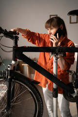 Woman repairman asking for help on fixing bike, call with mechanic, repair broken bicycle at home