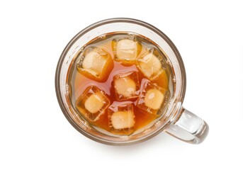 Iced tea in a glass mug with ice cubes on a white background from above