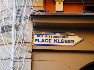 Directional street sign in Strasbourg points towards Place Kleber, featuring multilingual text for...