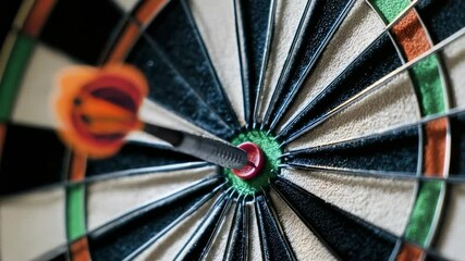 Player skillfully hits bullseye in intense darts match at local pub with friends
