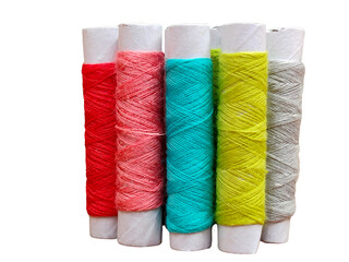 Five rolls of colorful twine wrapped around white cylindrical cores in red, pink, blue, yellow, and beige colors.