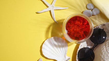 Arranged flat lay of cold refreshing summer beverage strawberry or cranberry drink, straw hat,...