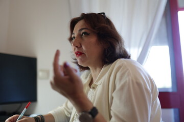 Businesswoman gesturing while talking during a meeting in the office