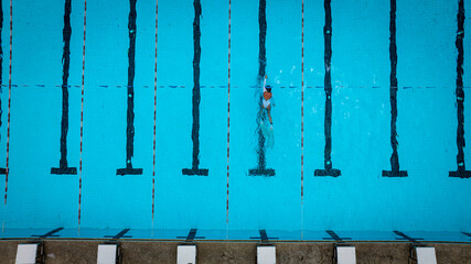 Top view with sport of woman swimming pool background