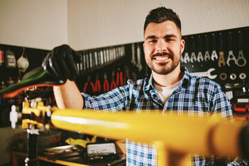 Bicycle mechanic repairing bike seat in workshop