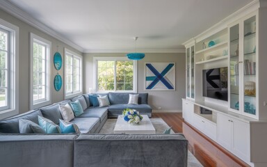 Contemporary interior design showcase l shaped gray velvet sofa with blue pillows – turquoise glass wall art, white built ins & geometric artwork in light filled living room 