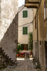 The narrowest street in the world, a narrow passage between the high walls of the old town, KRK in Croatia, a tourist attraction