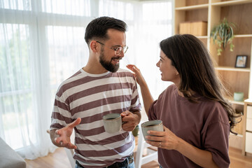 Young couple enjoying coffee and conversation at home