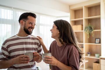 Happy couple enjoying coffee and conversation at home