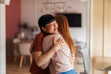 Two Women Sharing a Warm and Emotional Hug Indoors