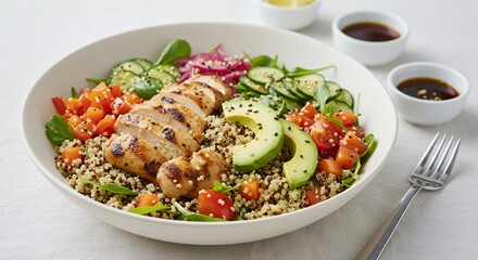 Savor the vibrant colors and fresh flavors of this healthy quinoa bowl, topped with grilled chicken and avocado.