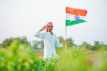 indian farmer waving national tricolor flag and saluting on independence day