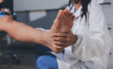 Physical therapist teaching a patient how to do exercises for his knee pain