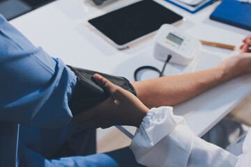 Doctor checking patient arterial blood pressure in hospital. Health care Concept