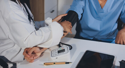 Doctor checking patient arterial blood pressure in hospital. Health care Concept