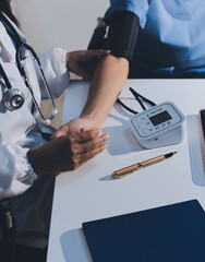 Doctor checking patient arterial blood pressure in hospital. Health care Concept