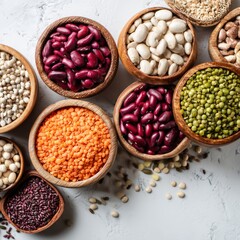 Fototapeta premium An overhead view of an assortment of fresh and colorful legumes arranged in wooden bowls