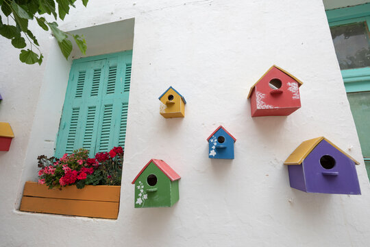 Colourful bird boxes on Greek taverna wall, Areopoli, Mani, Peloponnese, Greece, Europe