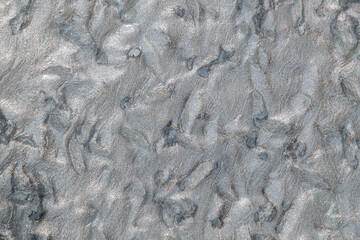 Textured silver gray surface with abstract patterns