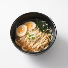 A bowl of ramen with egg and seaweed isolated on white background