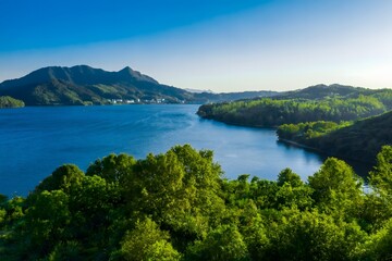 Obraz premium lake and mountains,The silent beauty of mountains, rivers and life,A blue dream amidst the greenery
