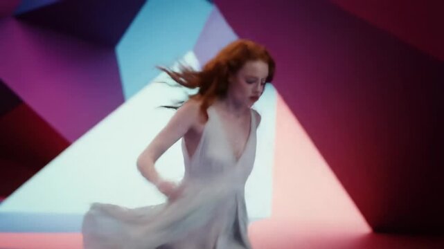 Red-haired woman in a flowing dress running through a surreal landscape of glowing geometric shapes