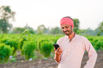 farmer using smartphone at agriculture field