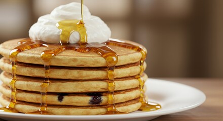 Golden Syrup Drizzles Delightfully onto a Stack of Fluffy Buttermilk Pancakes Topped with Creamy Whipped Cream.