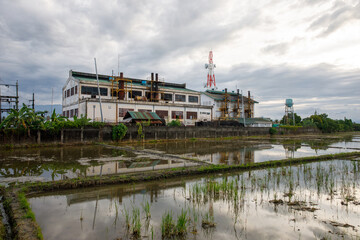 Abandoned Industrial Building Reflected in Flooded Rice Fields