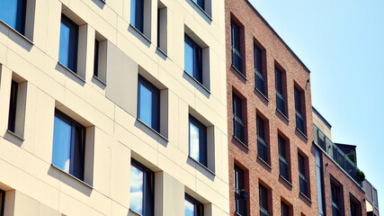 Modern apartment buildings on a sunny day with a blue sky. Facade of a modern apartment building. Modern residential apartment building complex condo.
