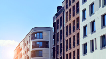 Modern apartment buildings on a sunny day with a blue sky. Facade of a modern apartment building....