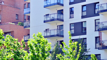 New modern block of flats in green area. complex. New modern block of flats in green area. European residential architecture harmonizing with nature. Eco-friendly living in city with greens.