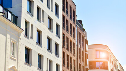 Modern apartment buildings on a sunny day with a blue sky. Facade of a modern apartment building....